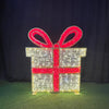 Decorative lighted gift box with a red bow on a dark background