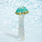 Decorative jellyfish ornament with a glittery texture on a light blue background
