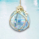 Decorative glass ornament with starfish and pearls on a light blue background