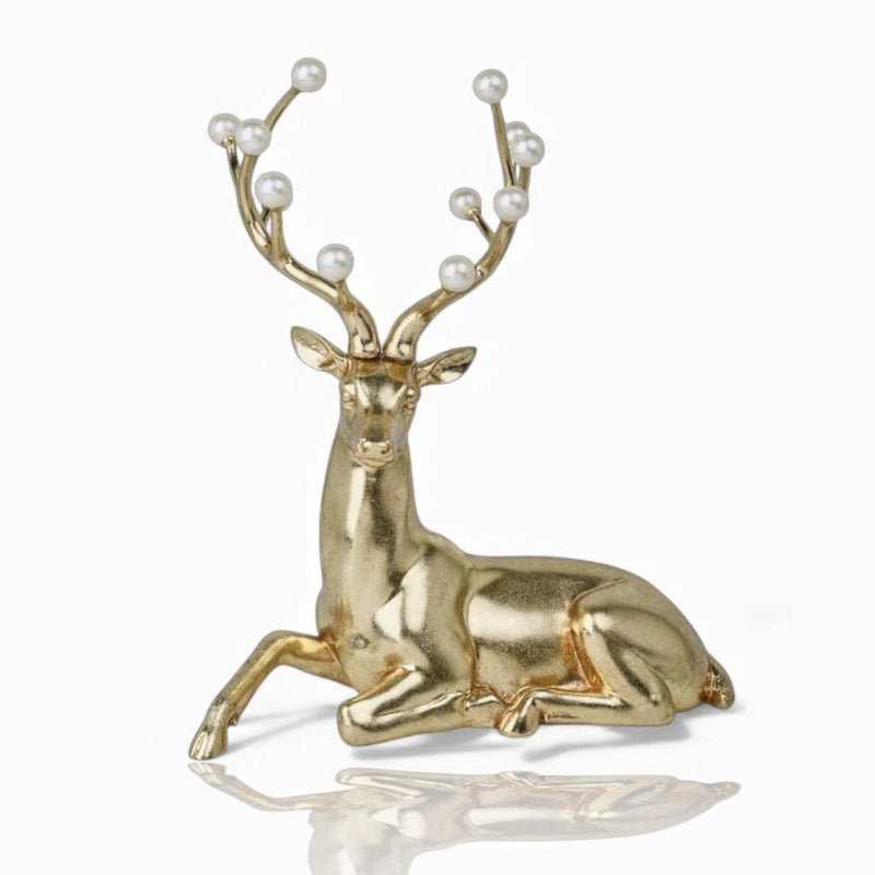 Gold deer figurine with pearl antlers on a white background