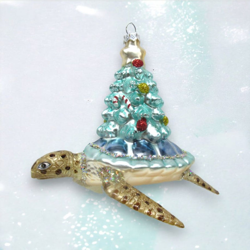 Decorative turtle ornament with a Christmas tree on a white background