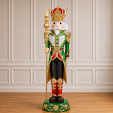 Decorative nutcracker figure with a crown in a room with paneled walls.