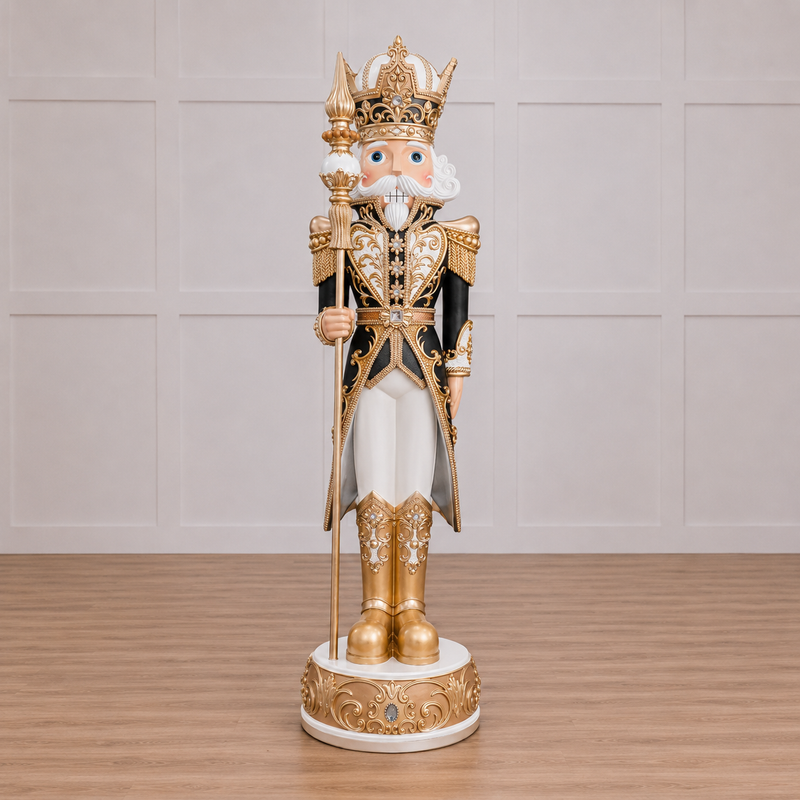 Decorative nutcracker figurine with gold and black attire on a wooden floor.