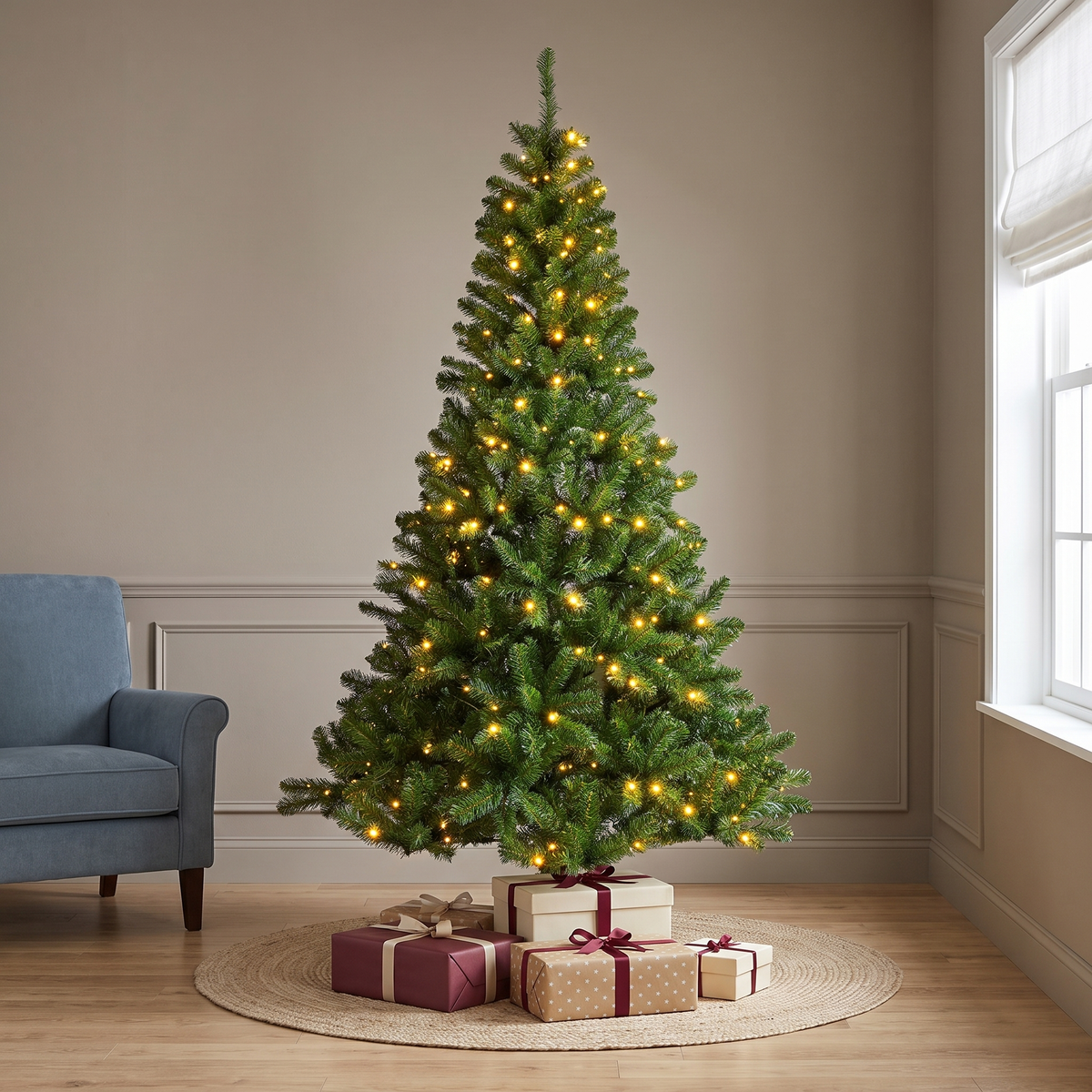 A pre-lit artificial Monarch Pine tree with warm white micro LED lights, placed in a room with holiday decorations.