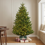 Decorated Christmas tree with lights in a room with a shelf and presents.