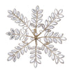 Decorative snowflake with white stones and gold accents on a white background