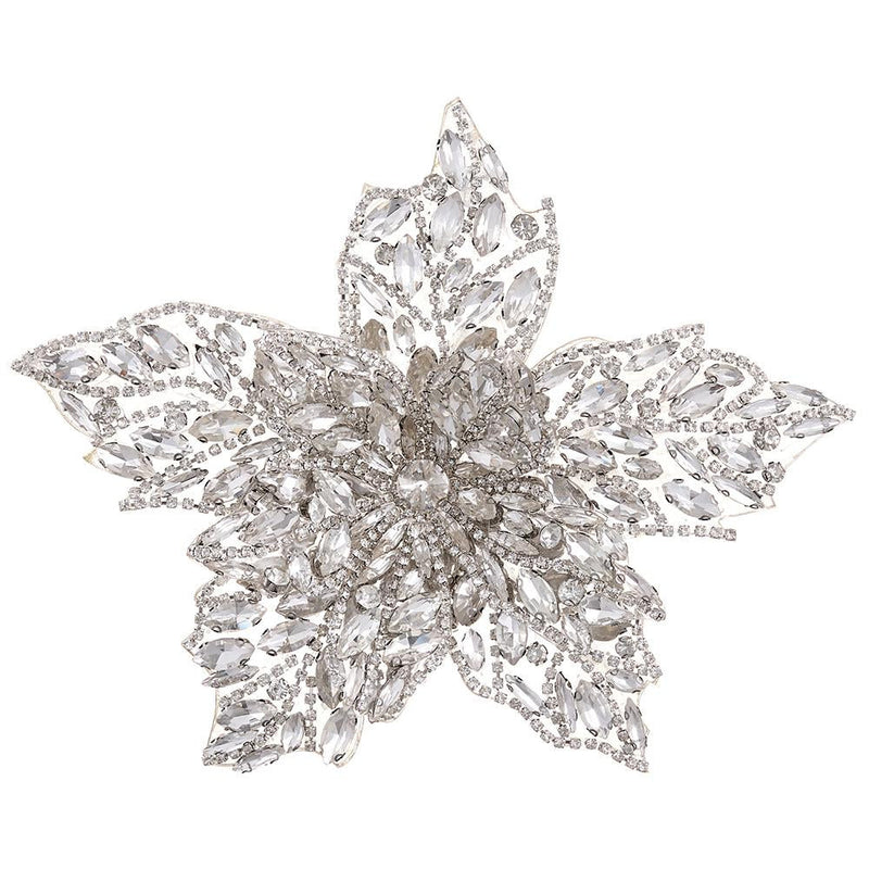 Decorative brooch with crystal-like stones on a white background