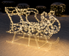 Decorative illuminated sleigh and reindeer figure on a snowy background