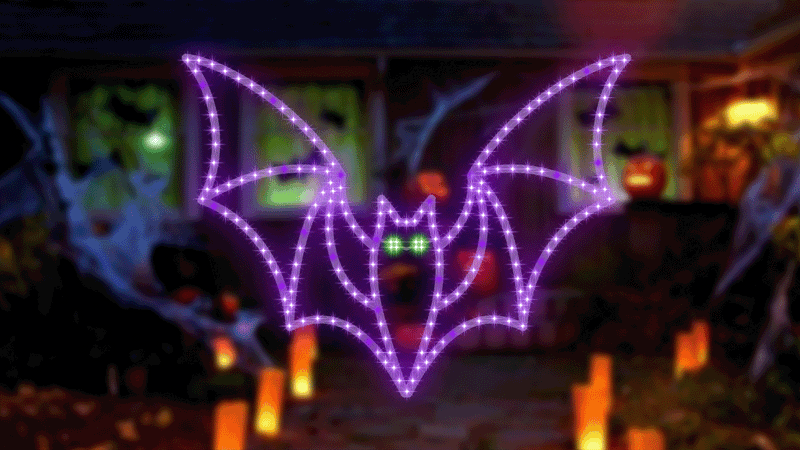 Decorative LED green and purple bat on a dark background