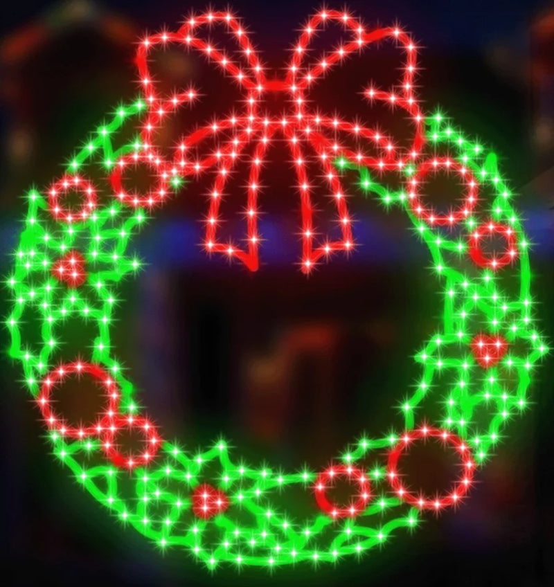 Decorative Christmas wreath with red bow and lights on a dark background
