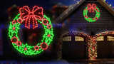 House with Christmas wreath lights on a dark night