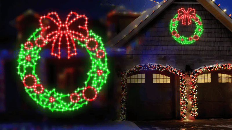 House with Christmas wreath lights on a dark night