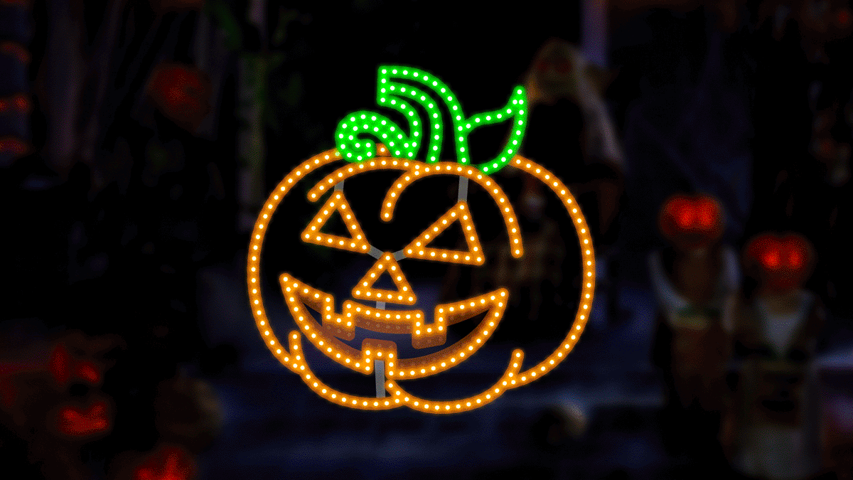 Decorative Halloween pumpkin with glowing face on a dark background