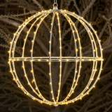 Decorative light sphere with string lights against a natural background