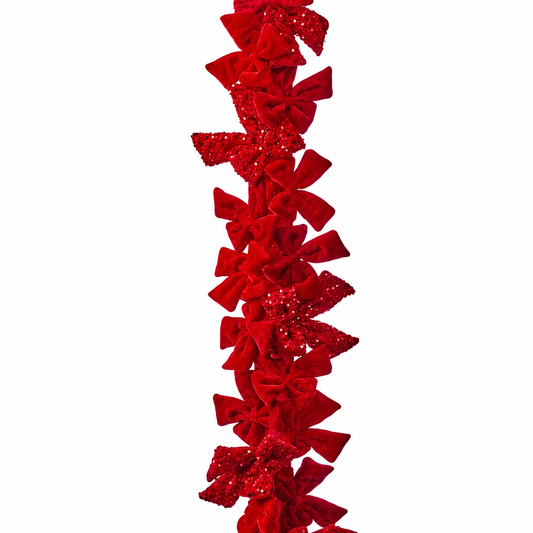 Red glittery bow garland on a white background
