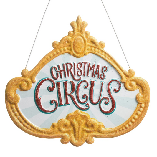 Decorative sign with 'Christmas Circus' text in a decorative gold frame.
