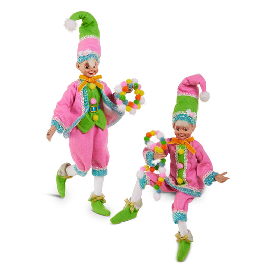 Two colorful elf dolls with green hats and pink outfits on a white background