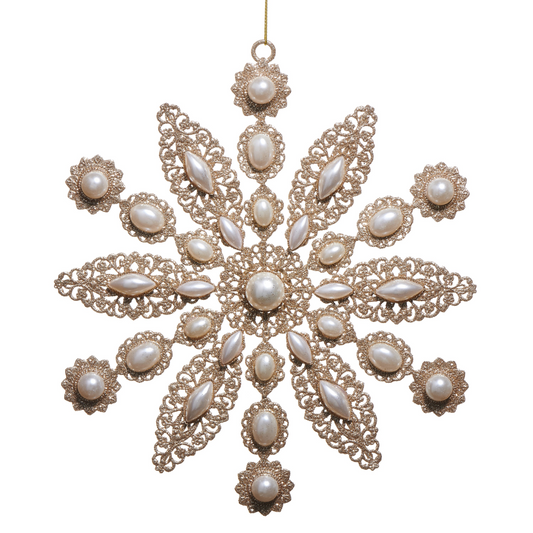 Decorative snowflake ornament with pearls on a white background