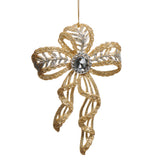 Decorative gold bow ornament with a central gem on a white background