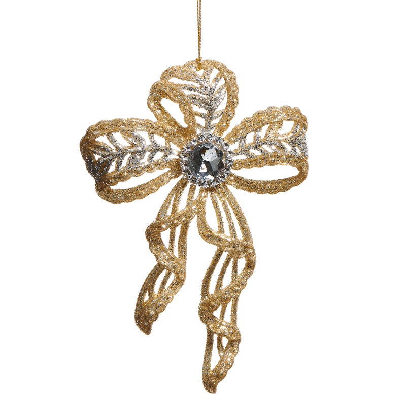 Decorative gold bow ornament with a central gem on a white background