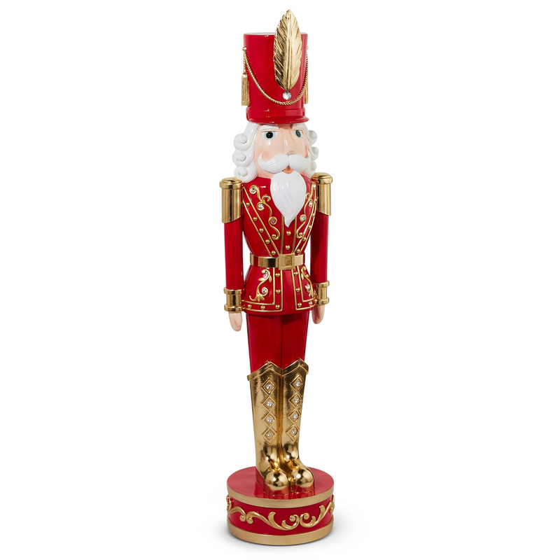 Decorative nutcracker figure in red and gold attire on a white background