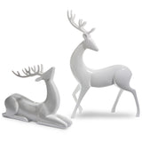 Two white ceramic deer figurines on a white background