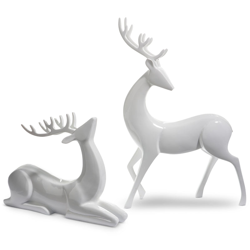 Two white ceramic deer figurines on a white background