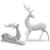 Two white ceramic deer figurines on a white background