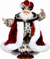 Decorative figure of a king in regal attire with a crown and fur-lined robe on a white background