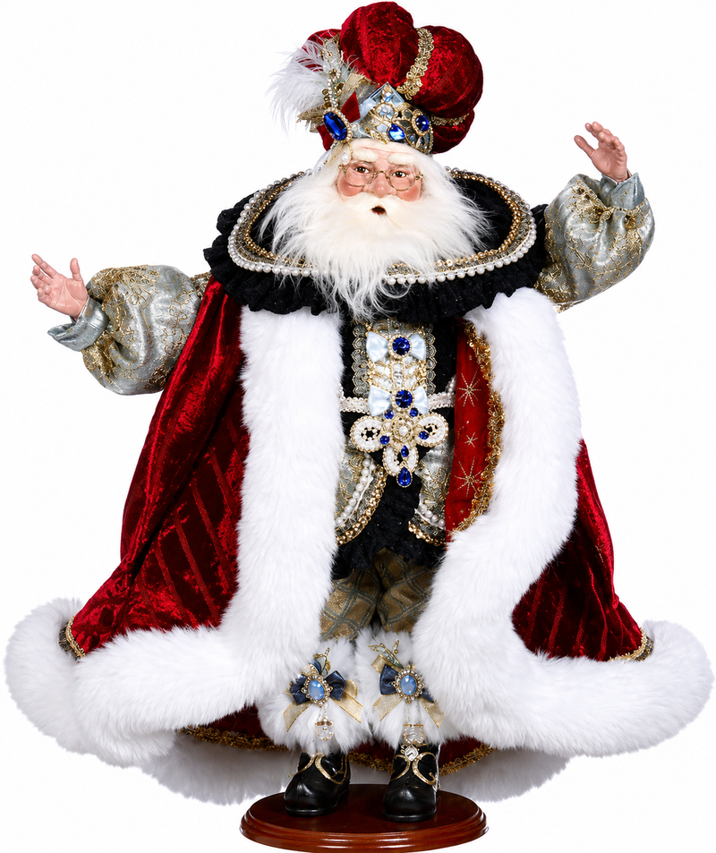 Decorative figure of a king in regal attire with a crown and fur-lined robe on a white background