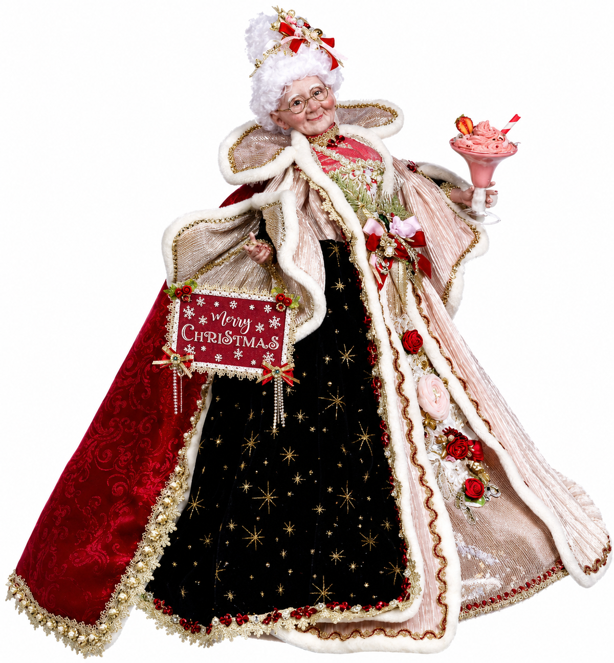 Decorative figure of a woman in festive attire with a 'Merry Christmas' sign, holding a pink cake.