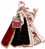 Decorative figure of a woman in festive attire with a 'Merry Christmas' sign, holding a pink cake.