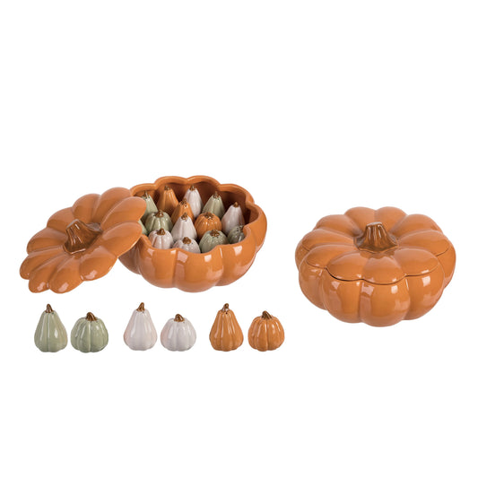 Pumpkin-shaped ceramic container with decorative gourds on a white background