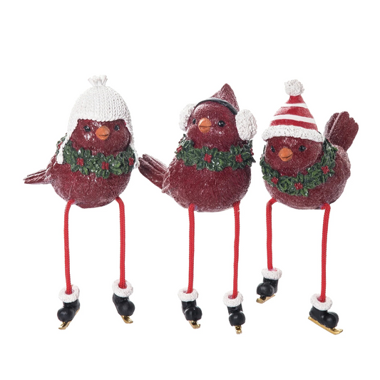 Three decorative birds with festive hats and skates on a white background