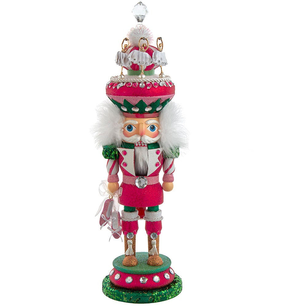 Decorative nutcracker figure with pink and white outfit on a white background