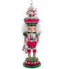 Decorative nutcracker figure with pink and white outfit on a white background