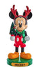 Mickey Mouse figurine with reindeer antlers and Christmas tree on a white background