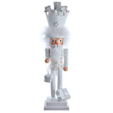 Decorative nutcracker figure with white outfit and crown on a white background