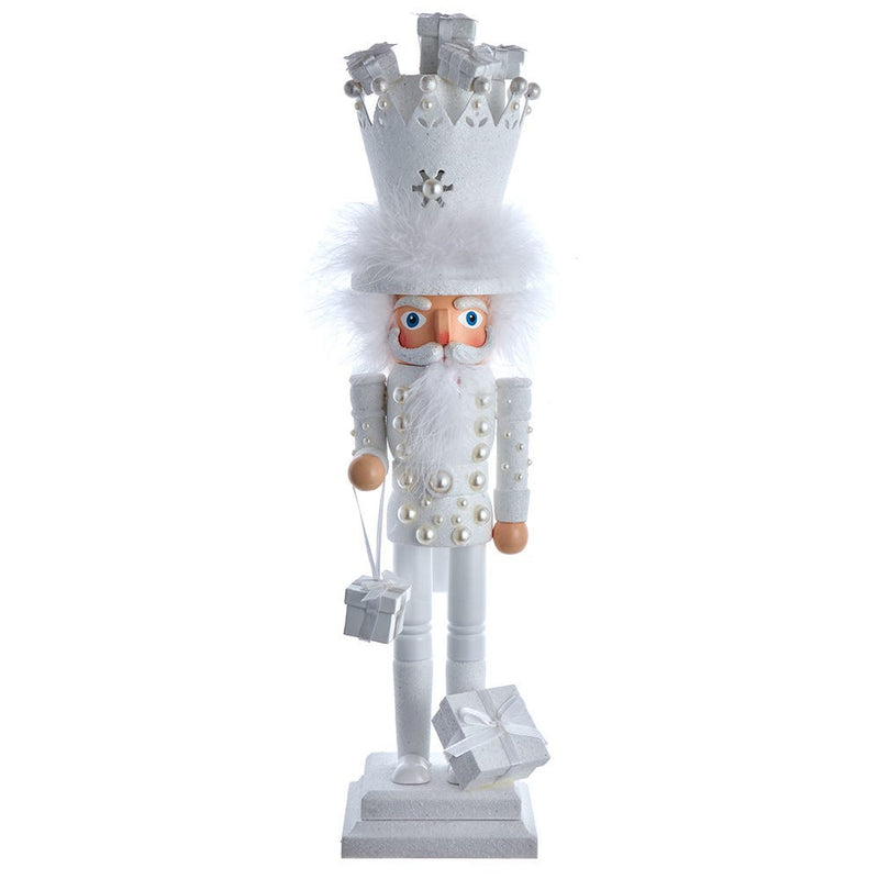 Decorative nutcracker figure with white outfit and crown on a white background