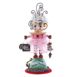 Decorative figurine of a character in a coffee-themed outfit with a 'Coffee Bar' sign.
