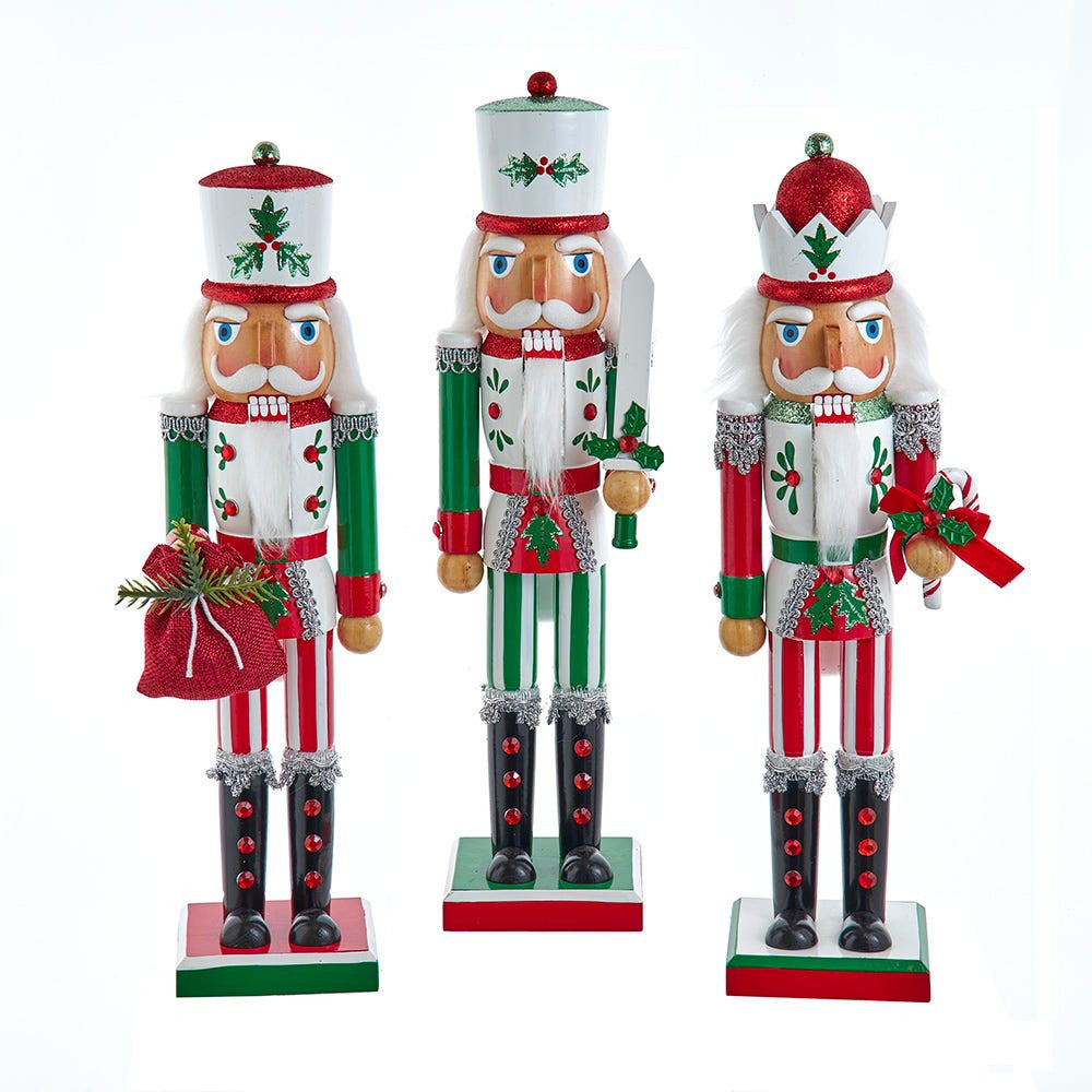 Three decorative nutcrackers with Christmas-themed outfits on a white background