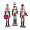 Three decorative nutcrackers with Christmas-themed outfits on a white background