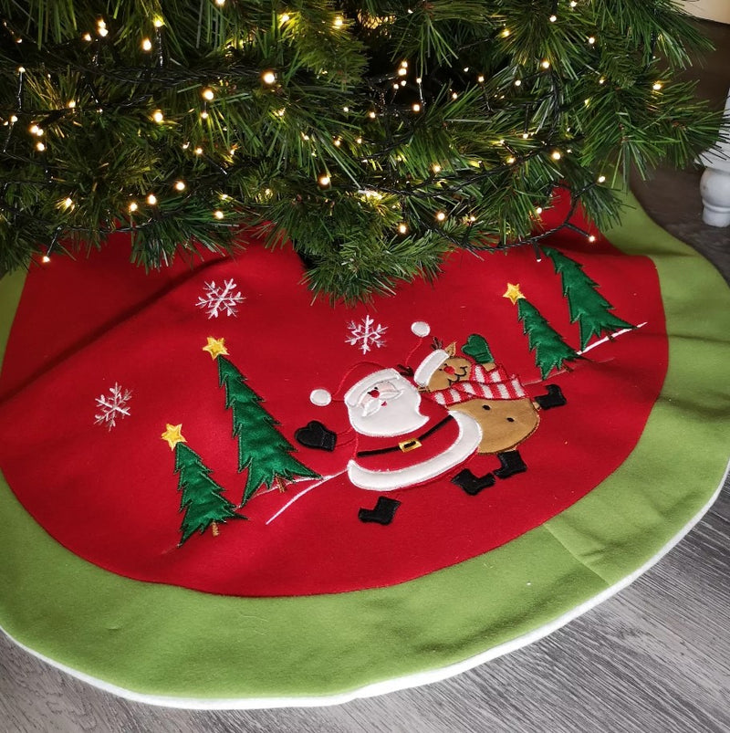 Decorative Christmas tree skirt with Santa Claus and reindeer design on a tree.
