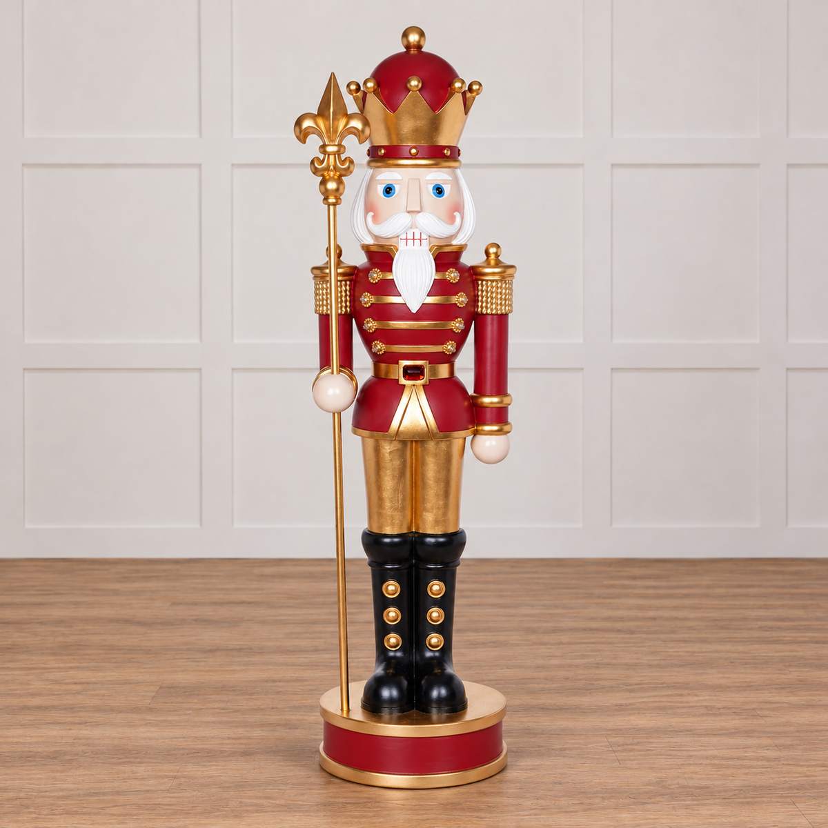 Decorative nutcracker figure with a crown and staff on a white background