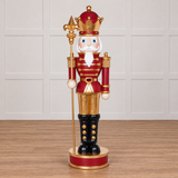 Decorative nutcracker figure with a crown and staff on a white background