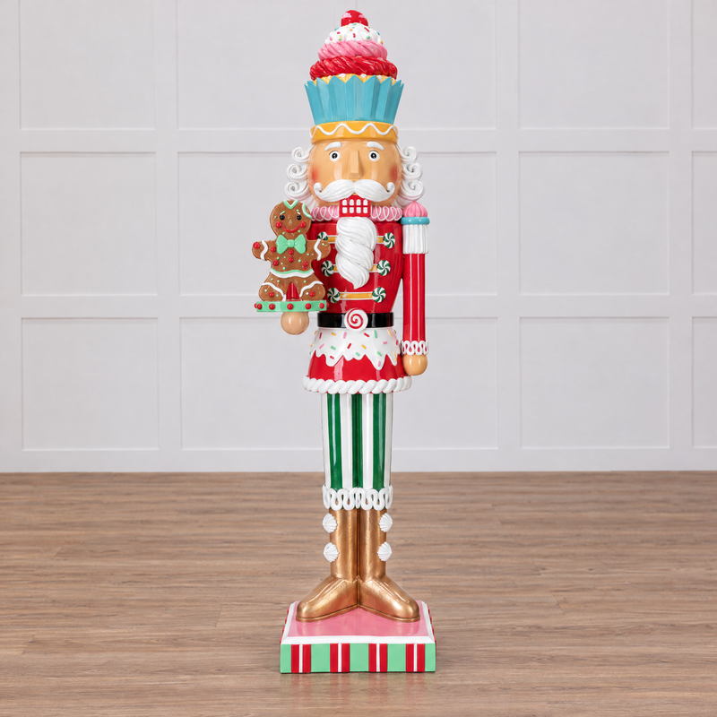 Decorative nutcracker figure with gingerbread theme on a white background
