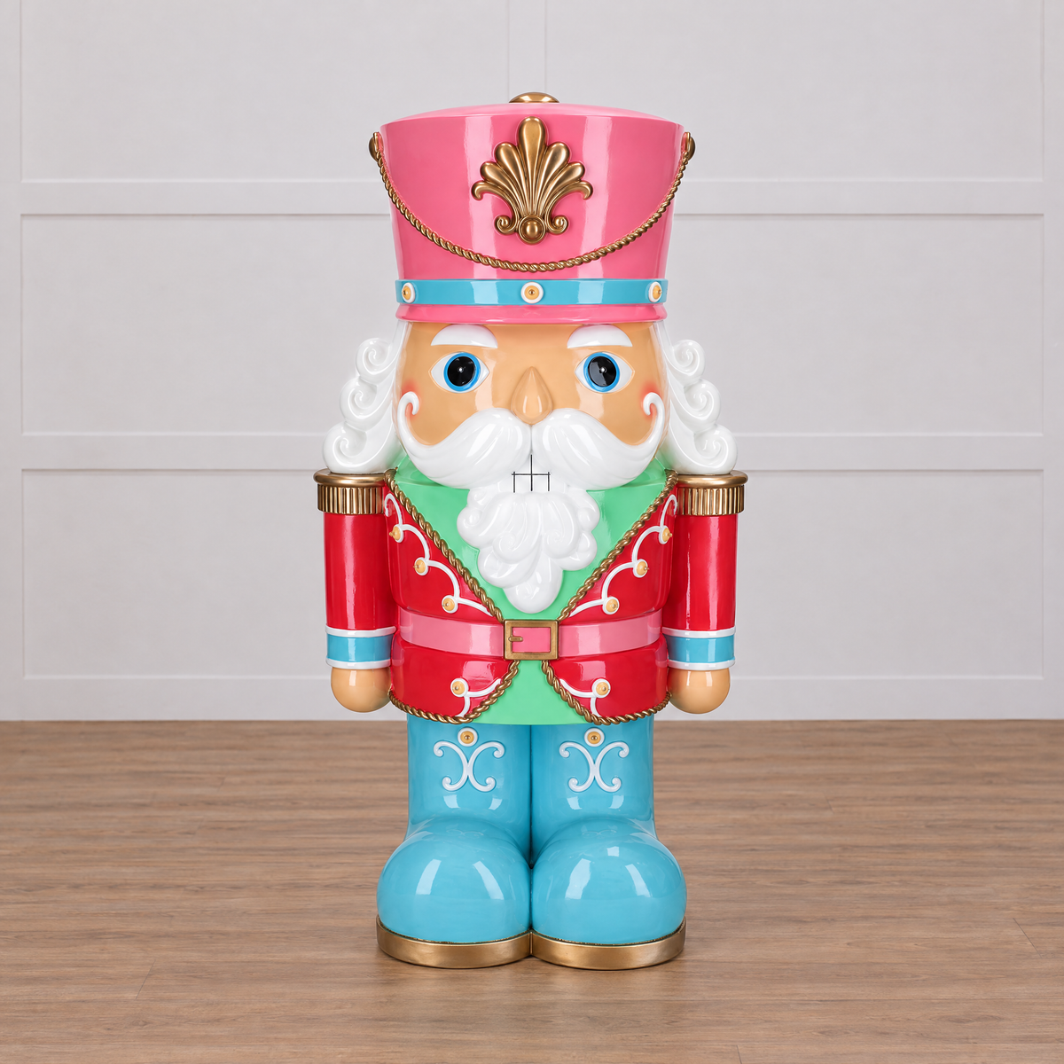 Colorful nutcracker figurine with a pink hat and blue shoes on a white background