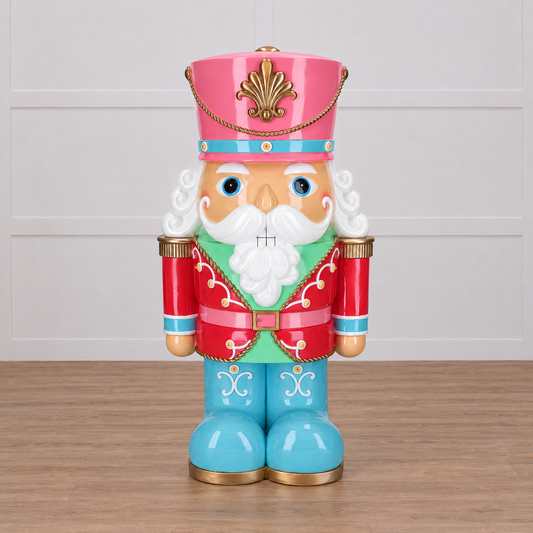 Colorful nutcracker figurine with a pink hat and blue shoes on a white background