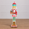 Decorative nutcracker figure with inset showing a gingerbread house scene