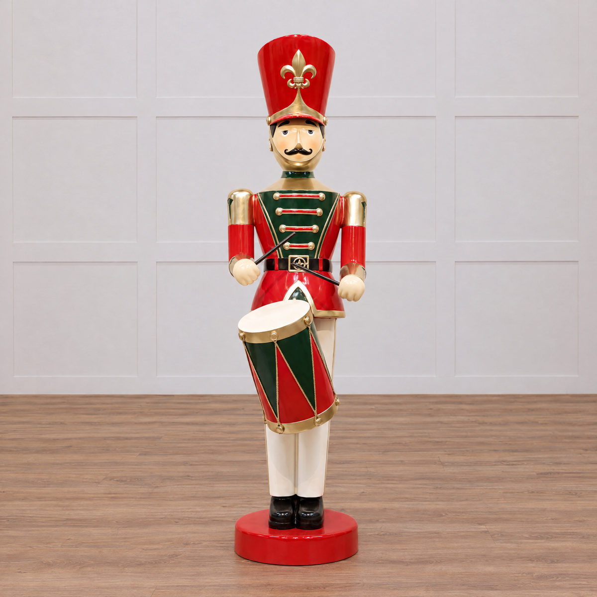 Decorative figure of a toy soldier with a drum on a beige background